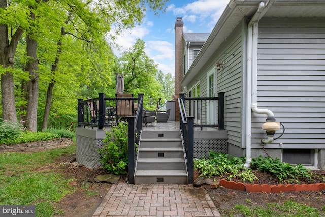 view of home's exterior featuring a chimney, a deck, and stairway