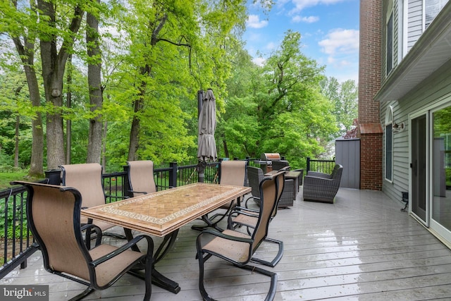 deck with outdoor dining area