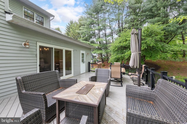 wooden terrace featuring outdoor dining area and an outdoor hangout area