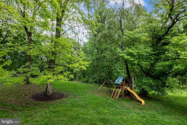 view of grassy yard featuring a playground