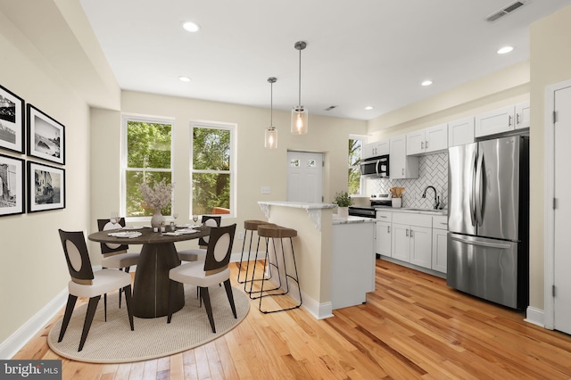3827 Boarman Ave, Baltimore, MD 21215 - kitchen with stainless steel appliances, healthy amount of natural light, a sink, light countertops, and recessed lighting