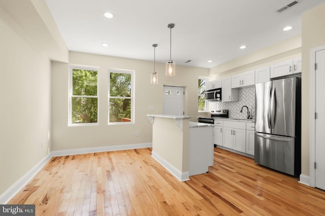 3827 Boarman Ave, Baltimore, MD 21215 - kitchen with stainless steel appliances, a sink, light wood-style flooring, plenty of natural light, and recessed lighting