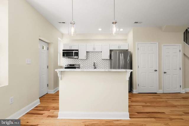 3827 Boarman Ave, Baltimore, MD 21215 - kitchen featuring stainless steel appliances, light wood-style floors, backsplash, light countertops, and baseboards