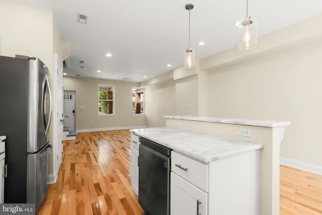 3827 Boarman Ave, Baltimore, MD 21215 - kitchen with freestanding refrigerator, a center island, dishwashing machine, light wood-style floors, and white cabinetry