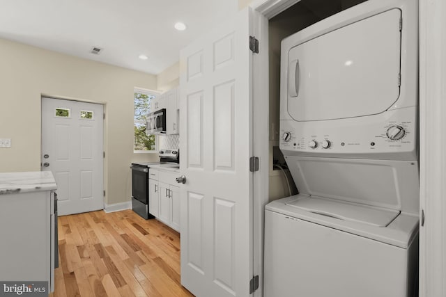 3827 Boarman Ave, Baltimore, MD 21215 - laundry area with stacked washer and clothes dryer, light wood finished floors, recessed lighting, and baseboards