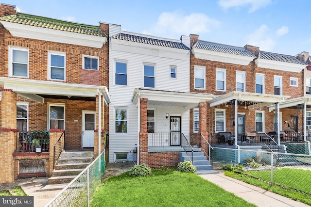 3827 Boarman Ave, Baltimore, MD 21215 - townhome / multi-family property with covered porch and brick siding