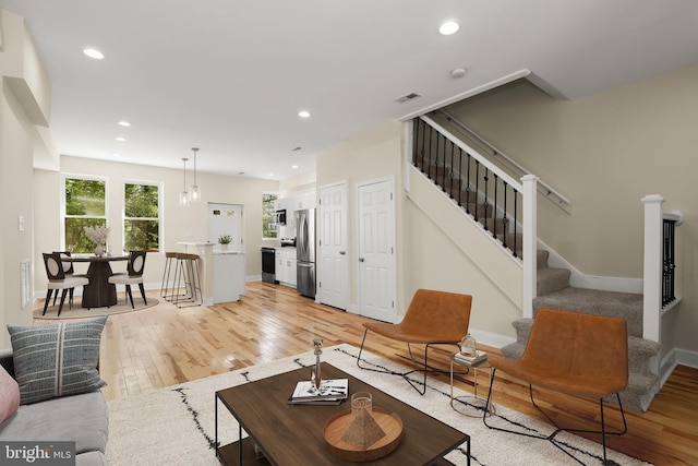3827 Boarman Ave, Baltimore, MD 21215 - living area with light wood-style floors, stairway, baseboards, and recessed lighting