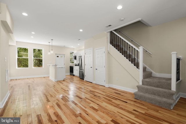3827 Boarman Ave, Baltimore, MD 21215 - unfurnished living room featuring light wood-style floors, stairs, baseboards, and recessed lighting