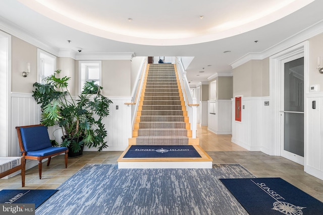 6 Fountain Dr E Unit 2B, Ocean City, MD 21842 - building lobby with a wainscoted wall, a decorative wall, stairs, and a surveillance system