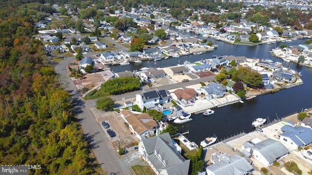 view of property location featuring a nearby body of water and nearby suburban area