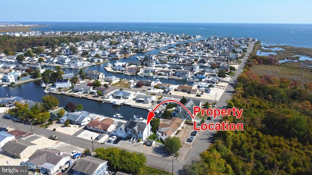 aerial overview of property's location featuring a nearby body of water and nearby suburban area