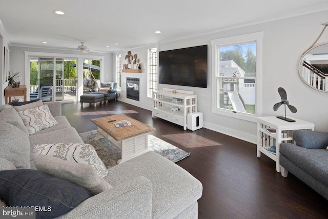 living area featuring ornamental molding, wood finished floors, recessed lighting, ceiling fan, and baseboards
