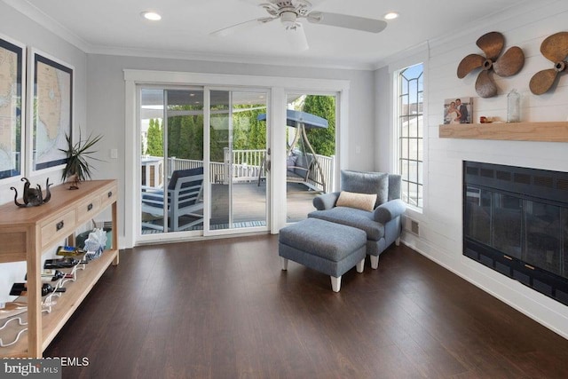 living area featuring ornamental molding, healthy amount of natural light, a ceiling fan, wood finished floors, and recessed lighting