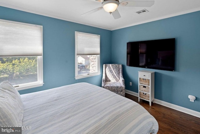 bedroom featuring multiple windows, wood finished floors, baseboards, crown molding, and ceiling fan