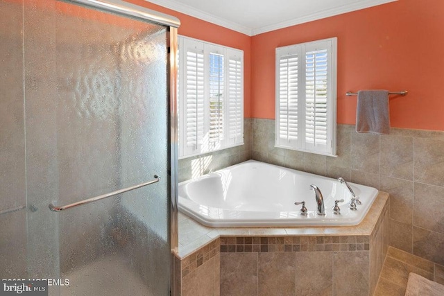 full bath featuring a shower stall, a bath, and ornamental molding