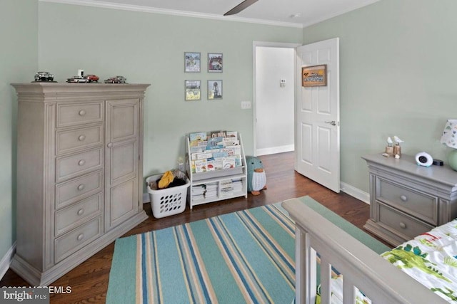 bedroom featuring dark wood-style floors, crown molding, and baseboards