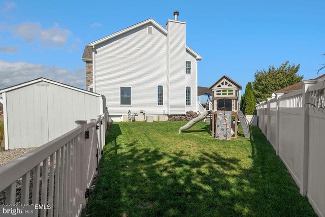 back of property featuring a playground and a chimney