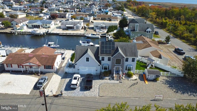 aerial perspective of suburban area with a nearby body of water