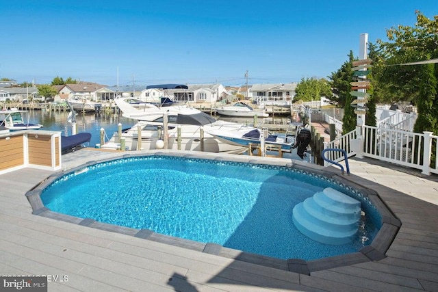 outdoor pool with a dock and a water view