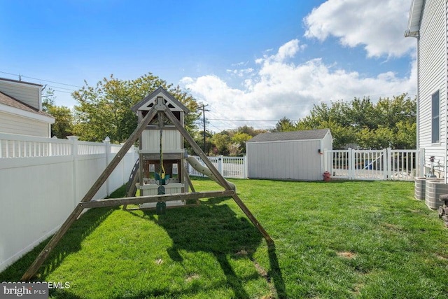 view of playground with a shed and an outbuilding