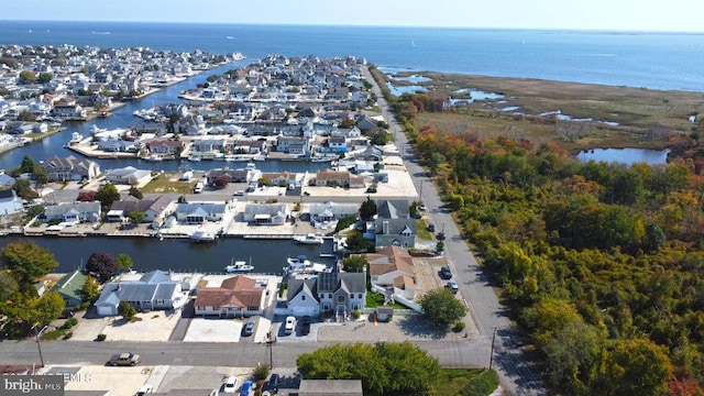 aerial view of property's location featuring a nearby body of water and nearby suburban area