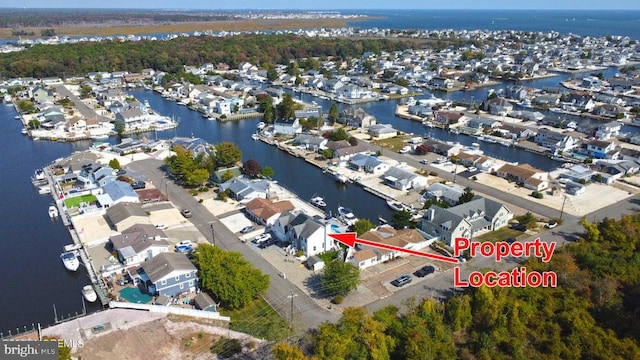 view of property location featuring a nearby body of water and nearby suburban area
