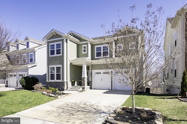 view of front of house with an attached garage, driveway, a front yard, and stone siding