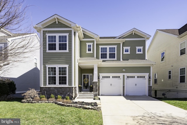 view of front facade with stone siding, driveway, a front yard, and a garage