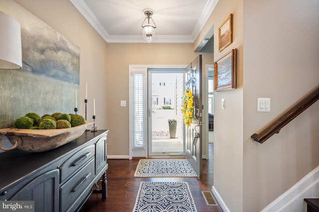 doorway featuring dark wood-type flooring, crown molding, plenty of natural light, and baseboards
