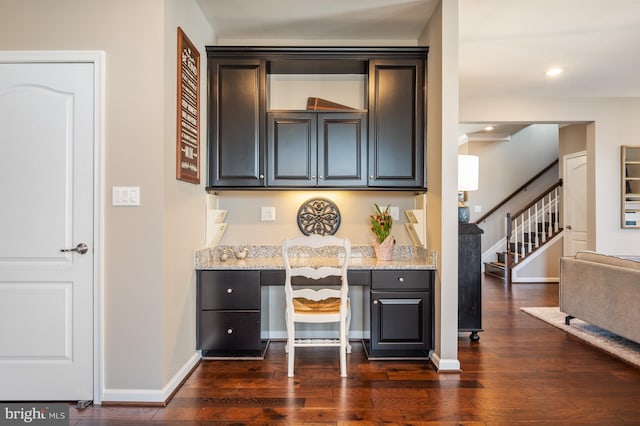 bar featuring dark wood-style flooring, stairway, baseboards, and recessed lighting