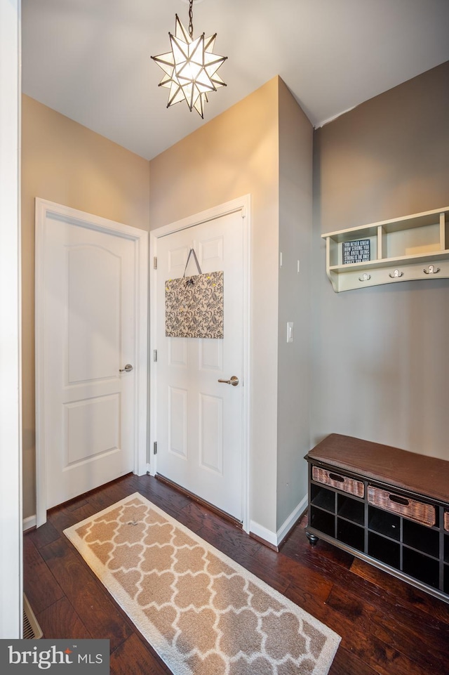foyer featuring wood-type flooring and baseboards