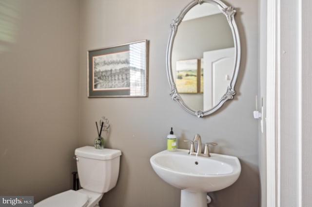 bathroom with toilet and a sink