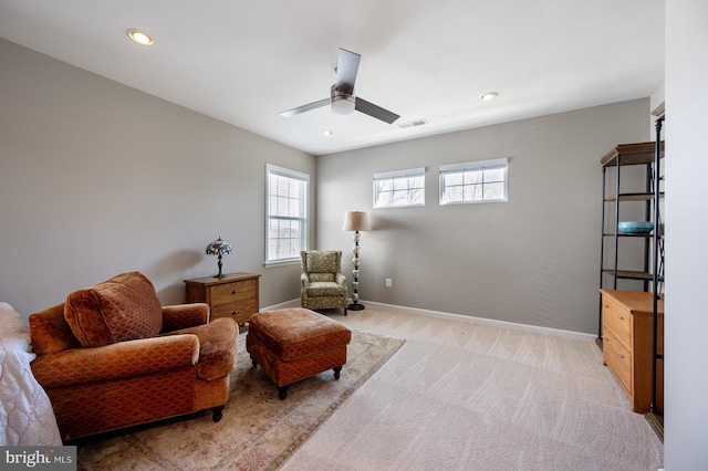 living area featuring light carpet, ceiling fan, baseboards, and recessed lighting
