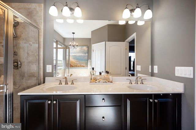 full bath with a stall shower, double vanity, and a chandelier