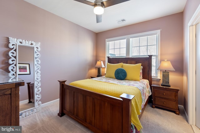 bedroom featuring light colored carpet, baseboards, and ceiling fan