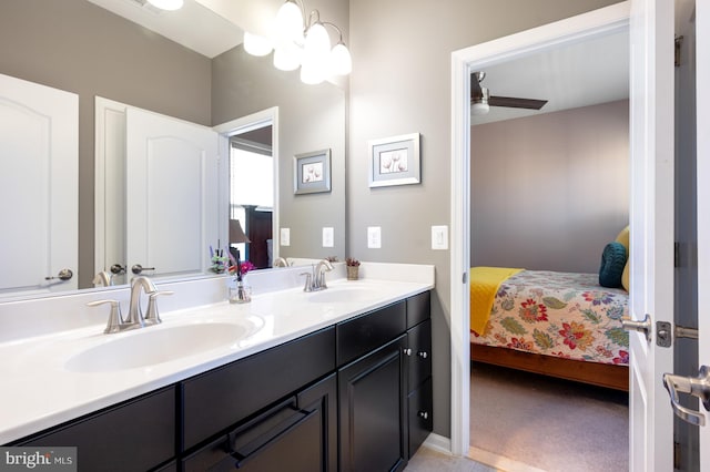 ensuite bathroom featuring double vanity and ceiling fan