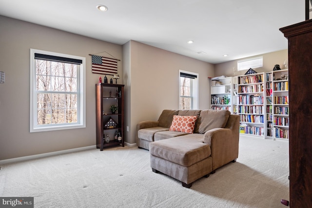 carpeted living area with baseboards and recessed lighting