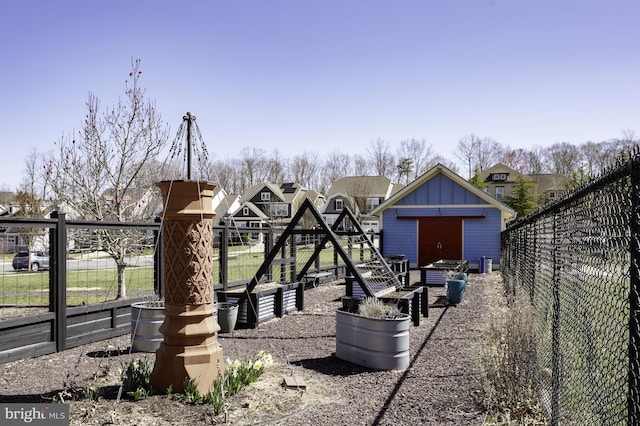 view of yard featuring fence, an outbuilding, and a shed