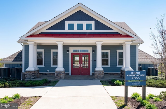 craftsman house featuring french doors, a porch, roof with shingles, and a standing seam roof