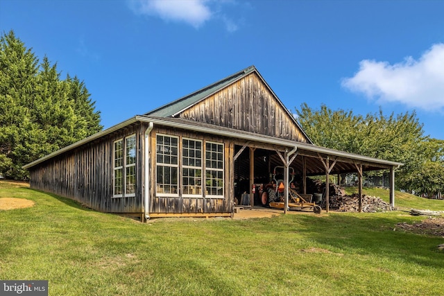 rear view of house featuring a yard
