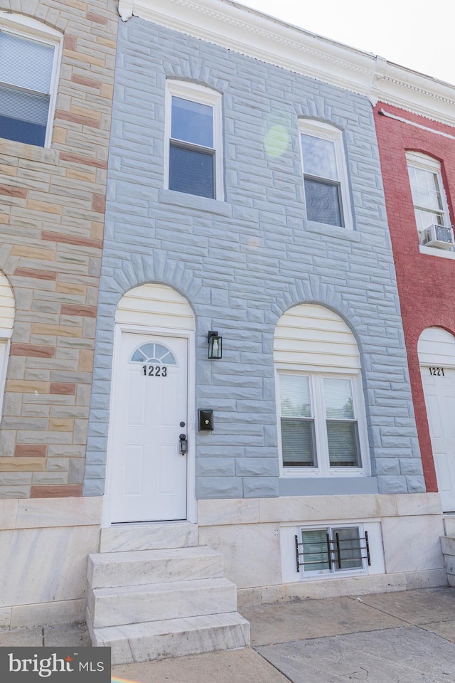 view of front of property with stone siding and entry steps