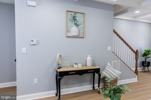 interior space featuring wood finished floors, baseboards, stairway, recessed lighting, and beam ceiling