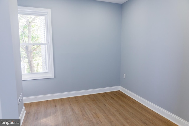 unfurnished room featuring wood finished floors and baseboards