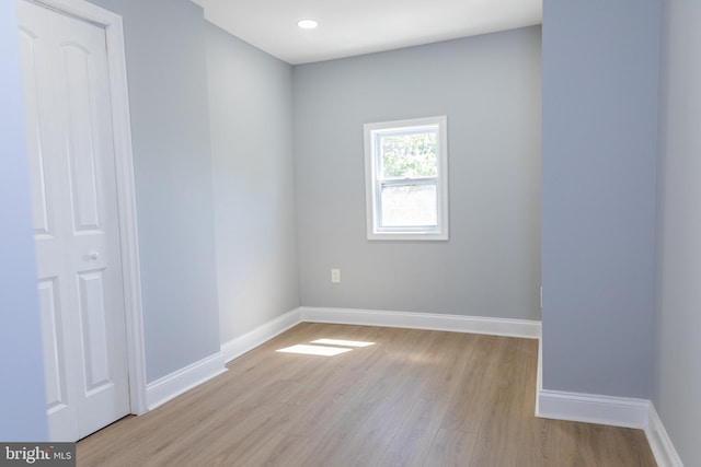 empty room with wood finished floors and baseboards