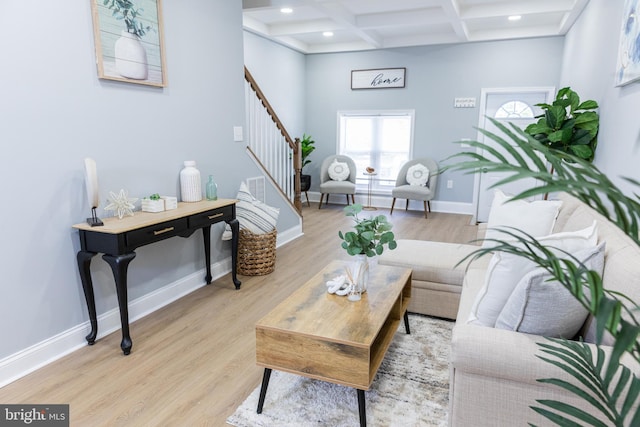 living room with stairway, beam ceiling, coffered ceiling, wood finished floors, and baseboards