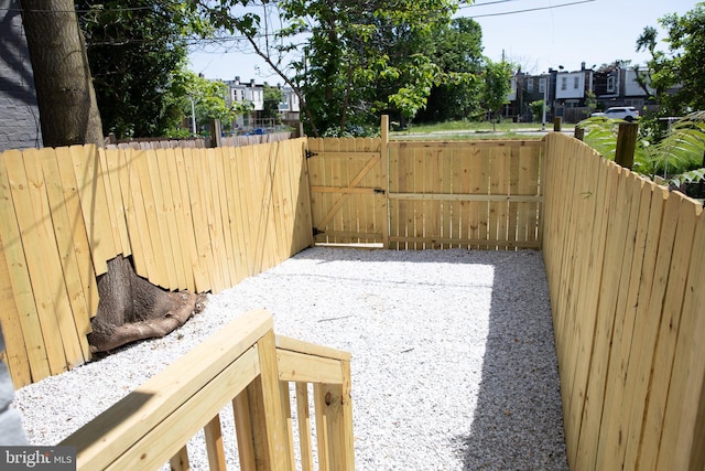 view of yard with a gate, fence, and a residential view