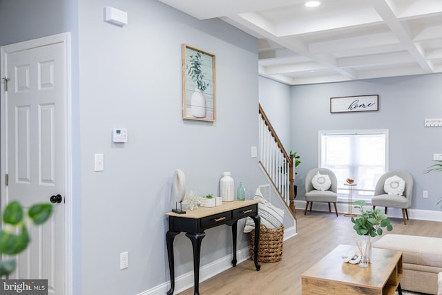 living room with beam ceiling, stairway, coffered ceiling, light wood-type flooring, and baseboards