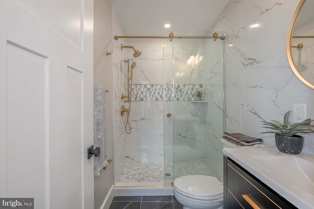 bathroom with a marble finish shower, toilet, vanity, and tile patterned flooring