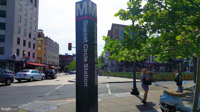 exterior space with sidewalks, a city view, curbs, and street lighting