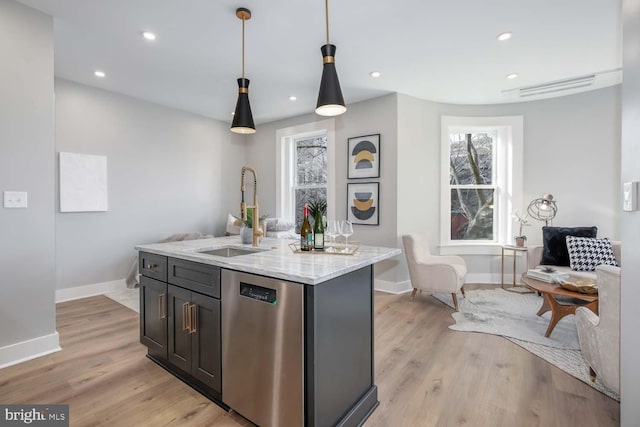 kitchen featuring dishwasher, a sink, baseboards, plenty of natural light, and recessed lighting